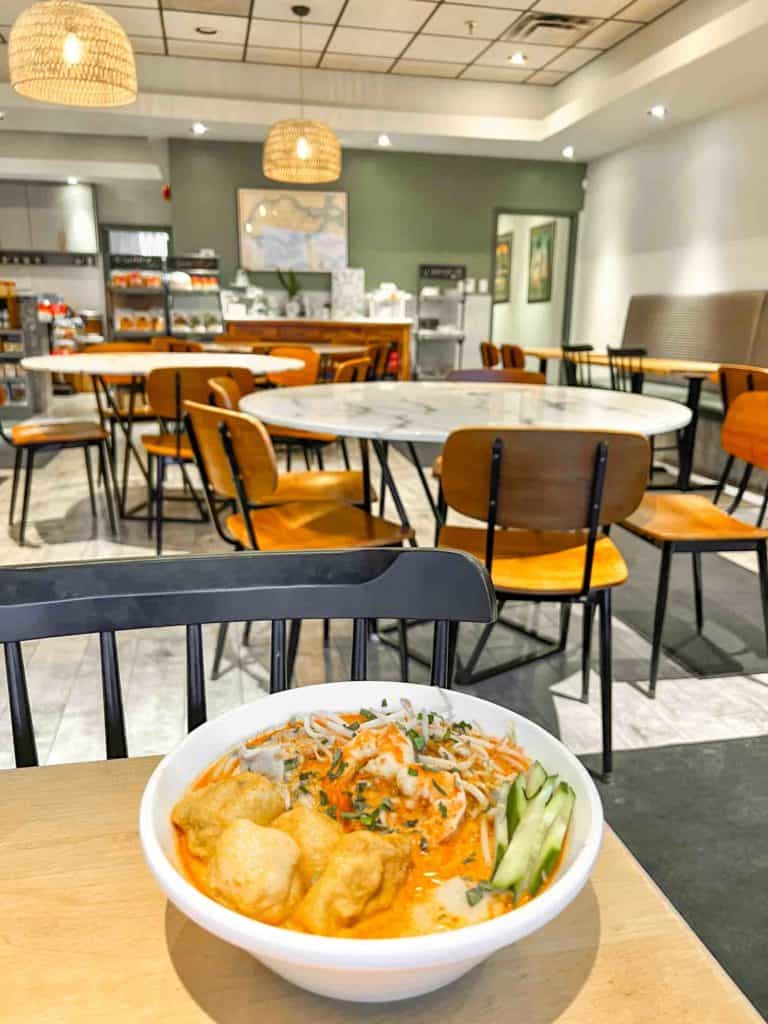 Lion City Mississauga Laksa on table with exterior of restaurant in background
