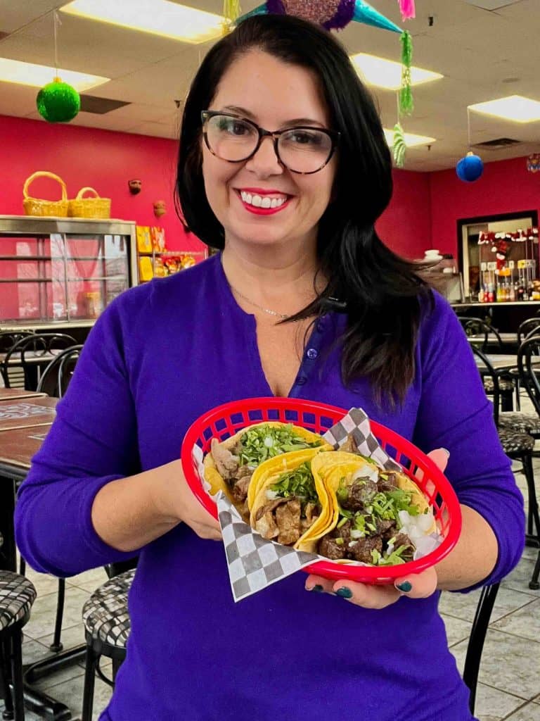 Ayngelina holding tacos from Pa'l Antojo Mexican restaurant in Mississauga