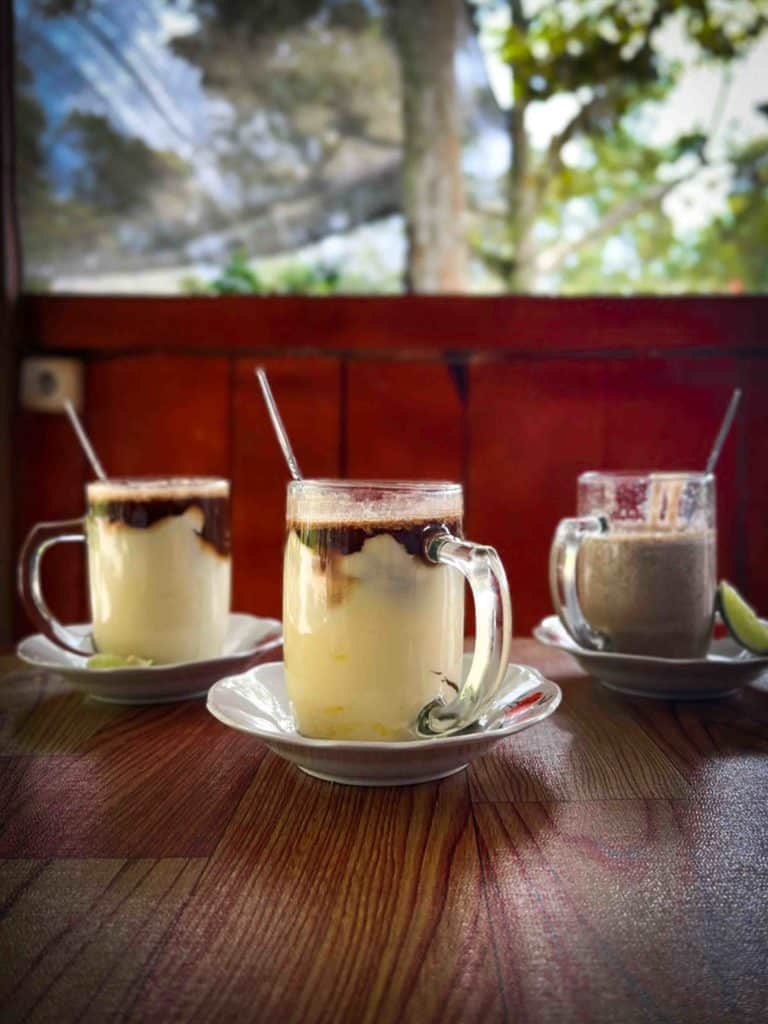 Teh talua or teh talur Indonesian egg tea in 3 varieties on a table