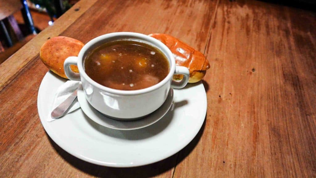 Aguapanela in white mug with bread