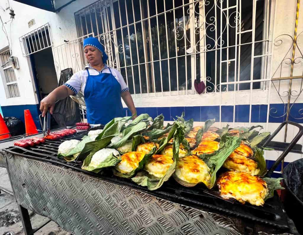 woman cooking at arepas yiya in Santa Marta, famous cheese stuffed arepas sold as street food after 4pm.