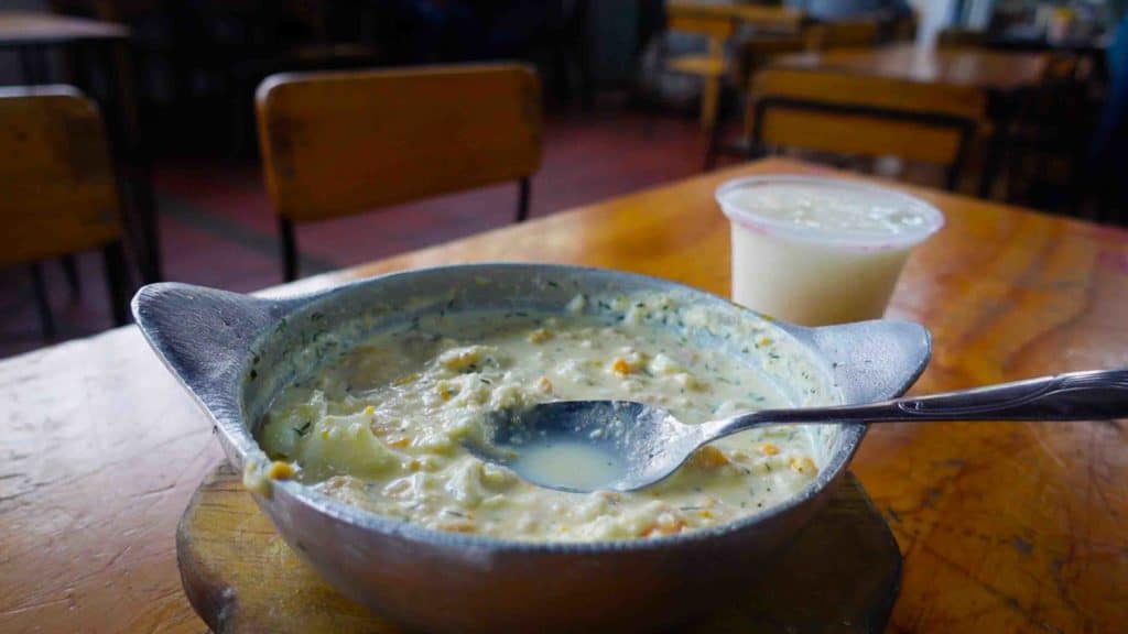 Changua breakfast in Bogota market on wooden table