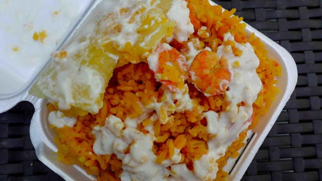 Colombian street food arroz con camerones in a styrofoam container