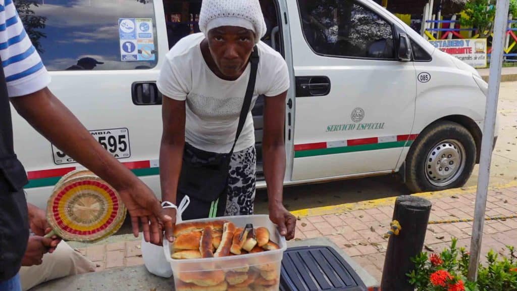 Woman selling pan de coco in Palengue Colombia