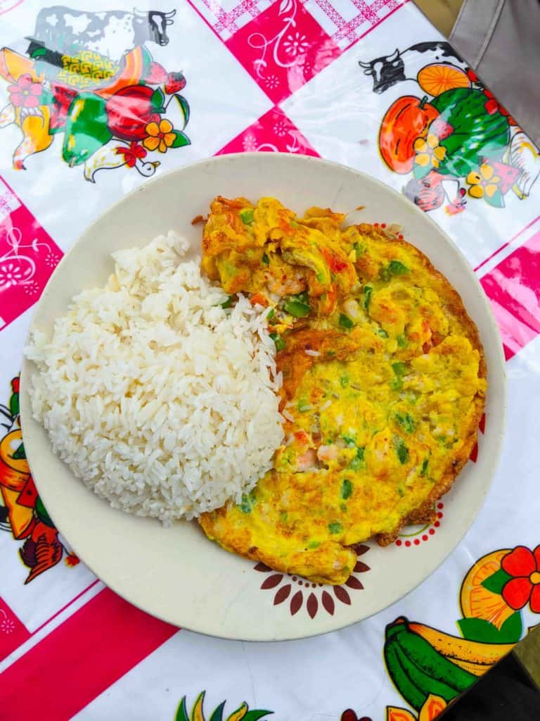 Huevos pericos and rice on white plate on colorful table