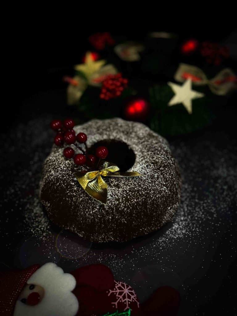 Colombian cake torta negra on a black table with Christmas holiday decorations