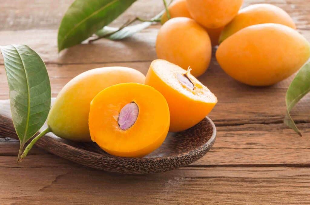 Gandaria indonesian fruits Closeup of ripe sweet marian plum ( Maprang, Mayongchid, Plum Mango) thai fruit on wooden table.