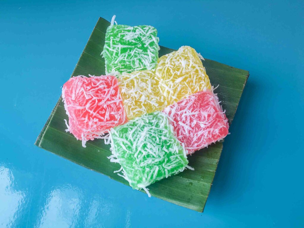 Cenil a Yogyakarta food made from a mixture of starch and granulated sugar , colored, shaped into small balls, eaten with grated coconut .