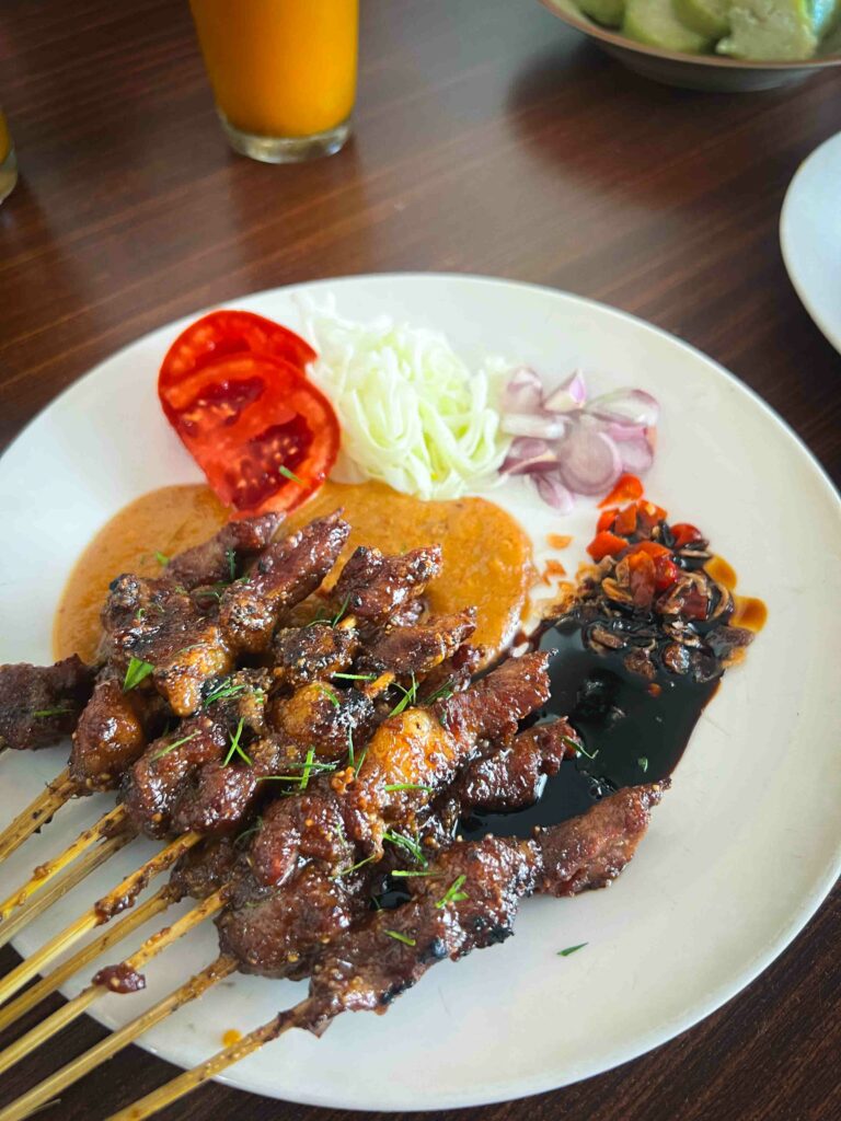 Sate kambing or grilled goat on a stick in a sweet peanut sauce from Malang