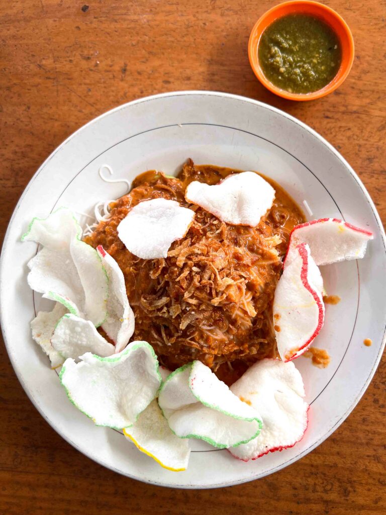 ketoprak in a white dish on a wooden table in Indonesia
