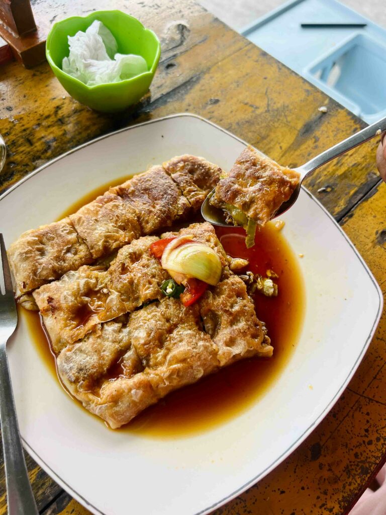 martabak telor common Indonesian street food on a plate in a sauce