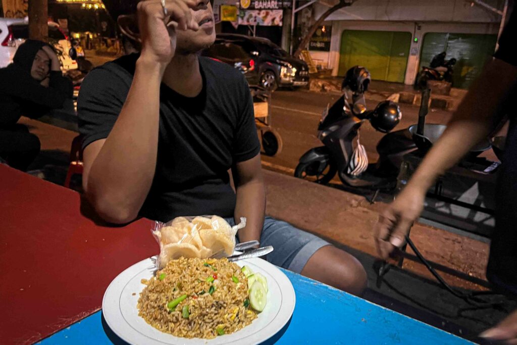 nasi goreng, Indonesian fried rice in Yogyakarta on a table at a Indonesian street food cart