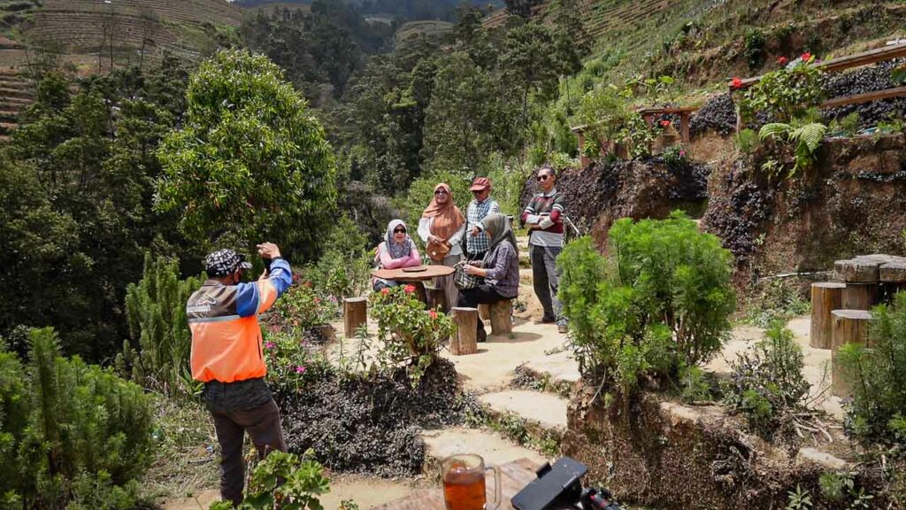 guide taking photo of guests in Dusun Butuh Central Java