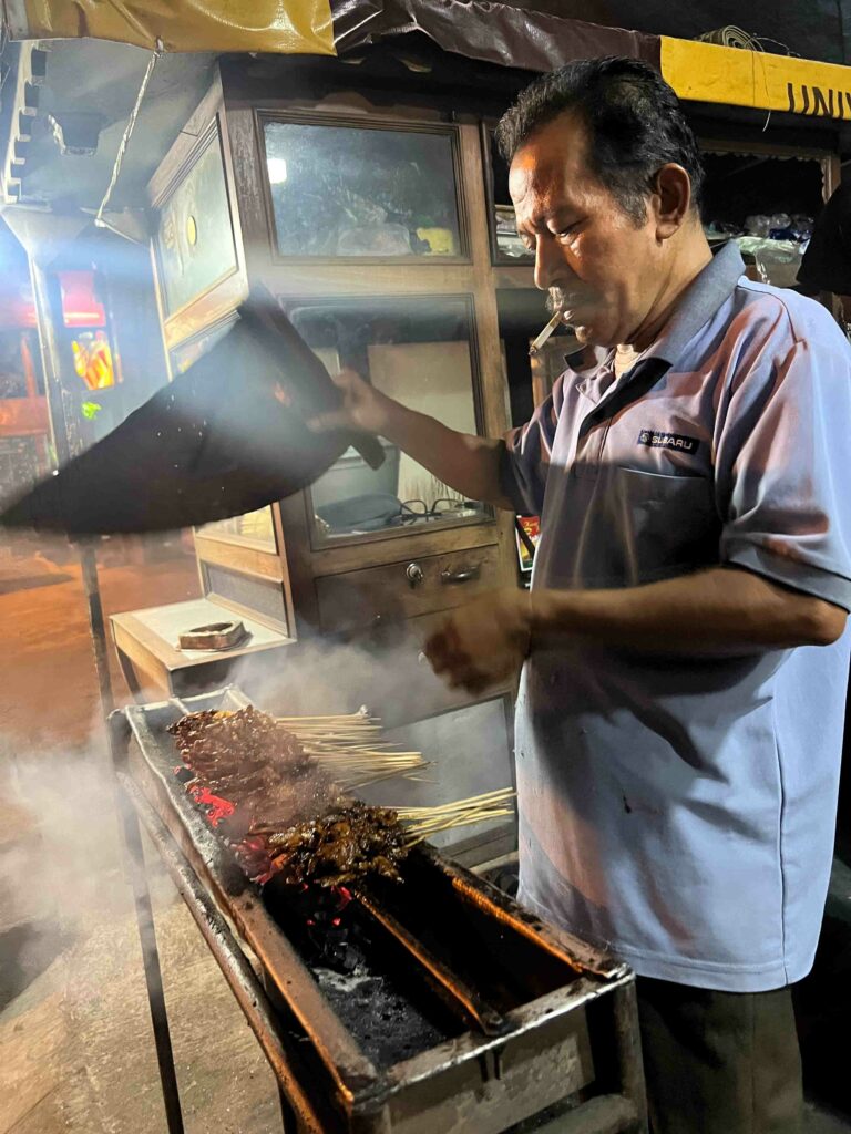 Sate kambing vendor cooking on hot coals