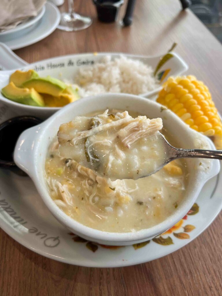 Christmas in Colombia food ajiaco in a white bowl on a table