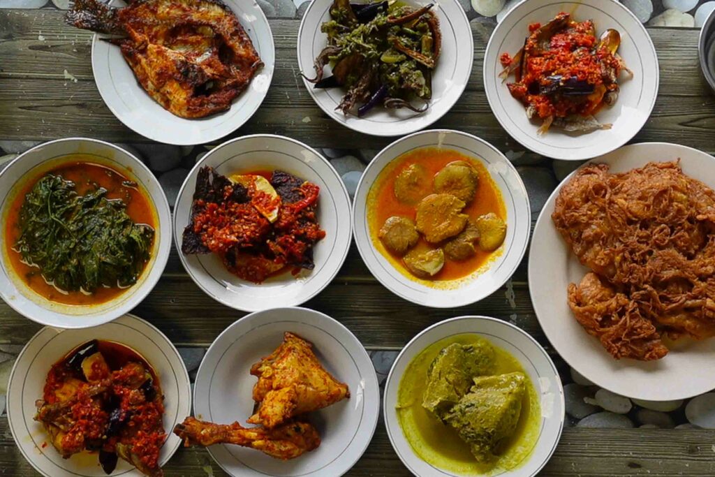 Masakan Padang restaurant with various plates on table