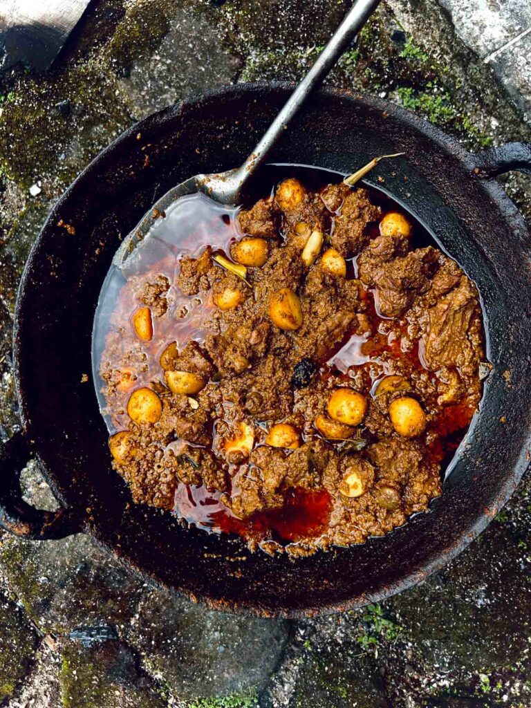 Rendang cooking over fire in Padang food typical to the city in Indonesia