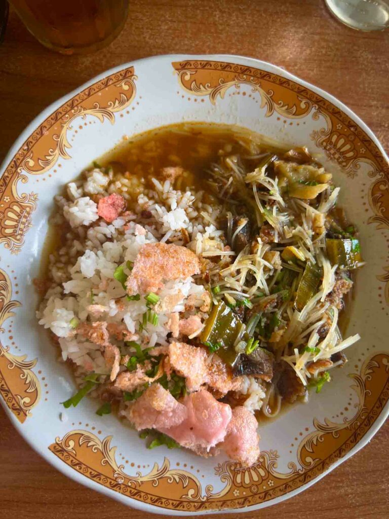 Soto Padang a beef noodle soup with rice in a bowl in Indonesia