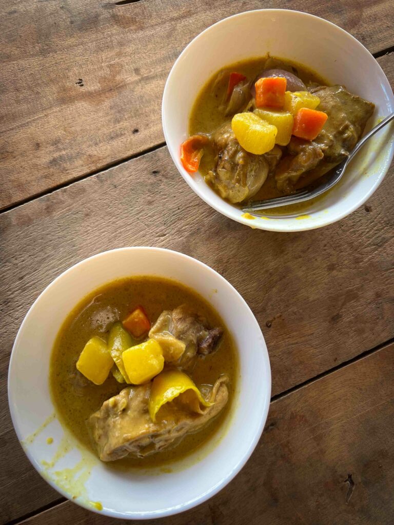 FIlipino Chicken curry in two bowls on wooden table