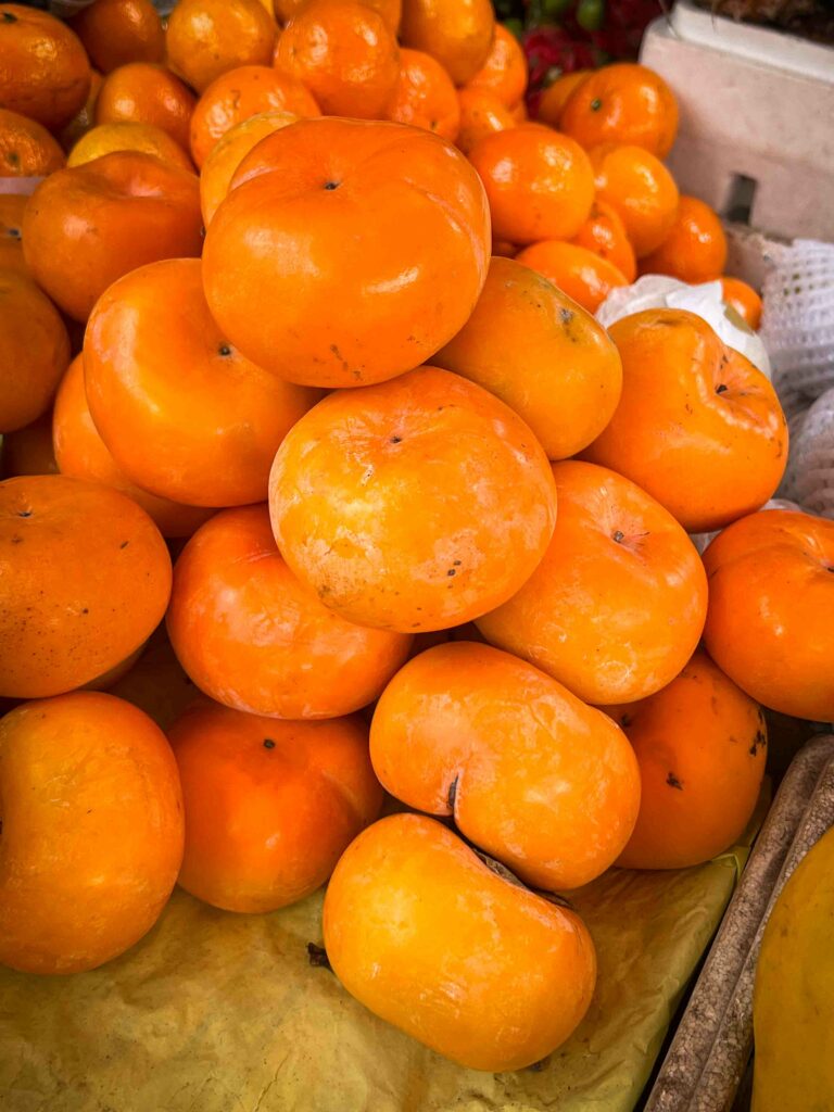 Cambodian fruits persimmons at fruit stand in Siem Reap