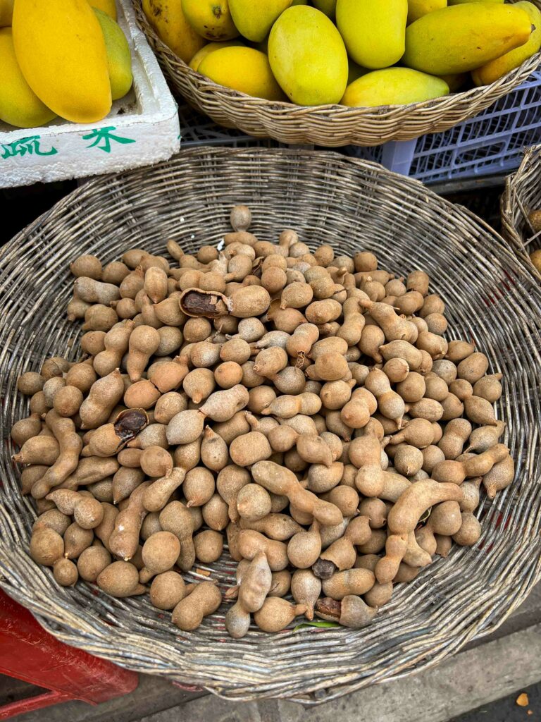 Cambodian fruit tamarind in basket at fruit stand in Siem Reap