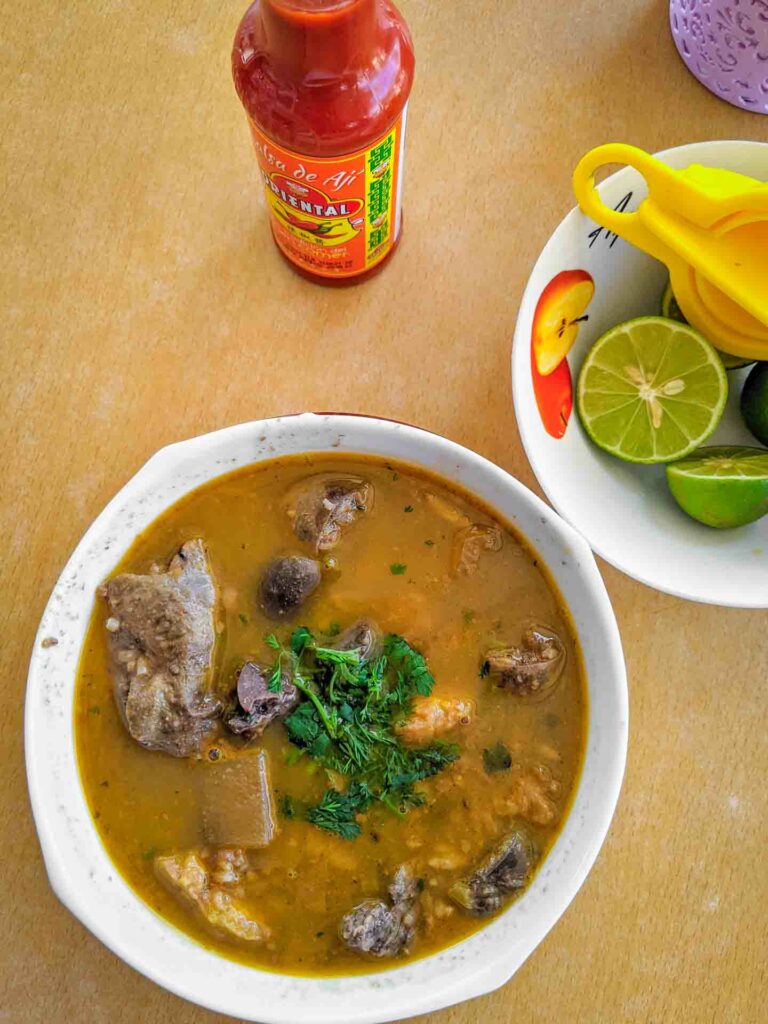 Caldo de salchicha an Ecuadorian soup in Playas made with blood sausages and innards served with hot sauce and lime