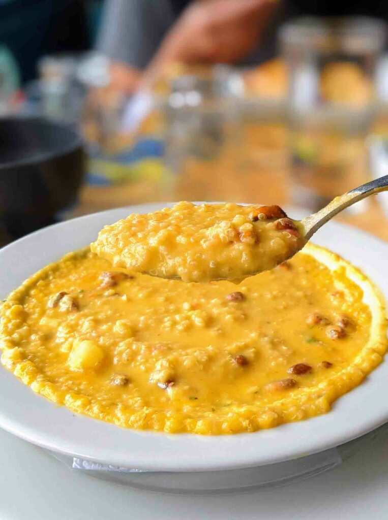 sopa de quinoa ecuadorian soup on a table with a soupful