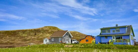 colorful houses in rolling green hills Magdalen Islands havre aux maisons