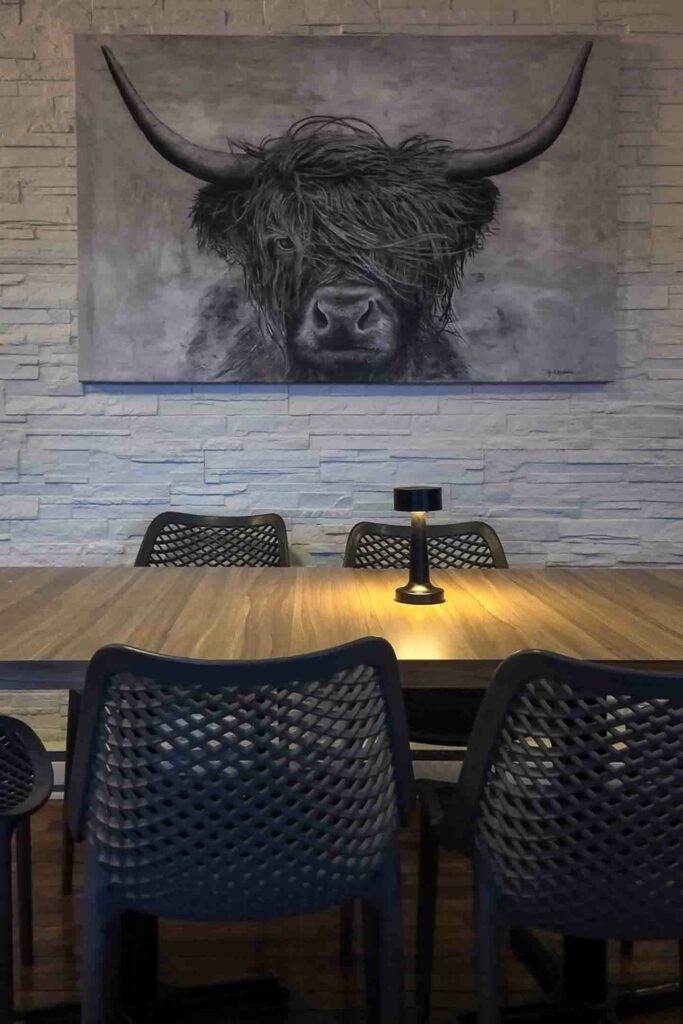 quai 360 interior table and artwork at Magdalen Islands