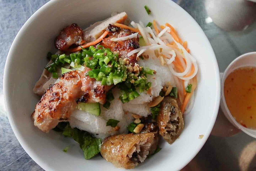 vietnamese bun thit nuong a popular Mekong Delta noodle in Vietnam with pork, southern style spring roll and thin vermicelli noodles