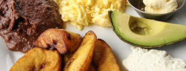 Desayuno tipico the most common breakfast in Honduras with beans, scrambled eggs, quesillo, sweet plains and avocado