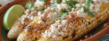 Elotes, Grilled Mexican Street Corn on the cob with cotija cheese, chili powder, mayonnaise