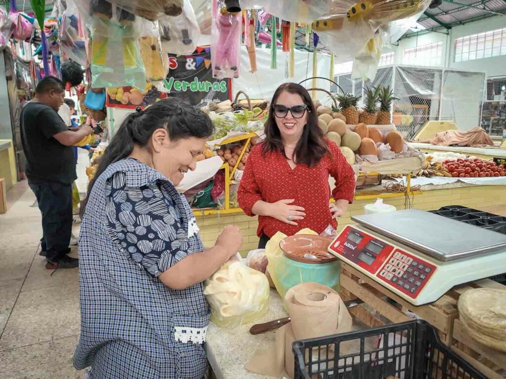 Puebla Market Ayngelina talking to vendor at Mercado del Carmen