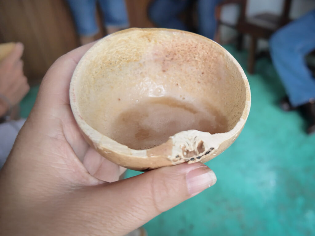 Pulque drink, traditional to Central highlands in Mexico, cup in woman's hand