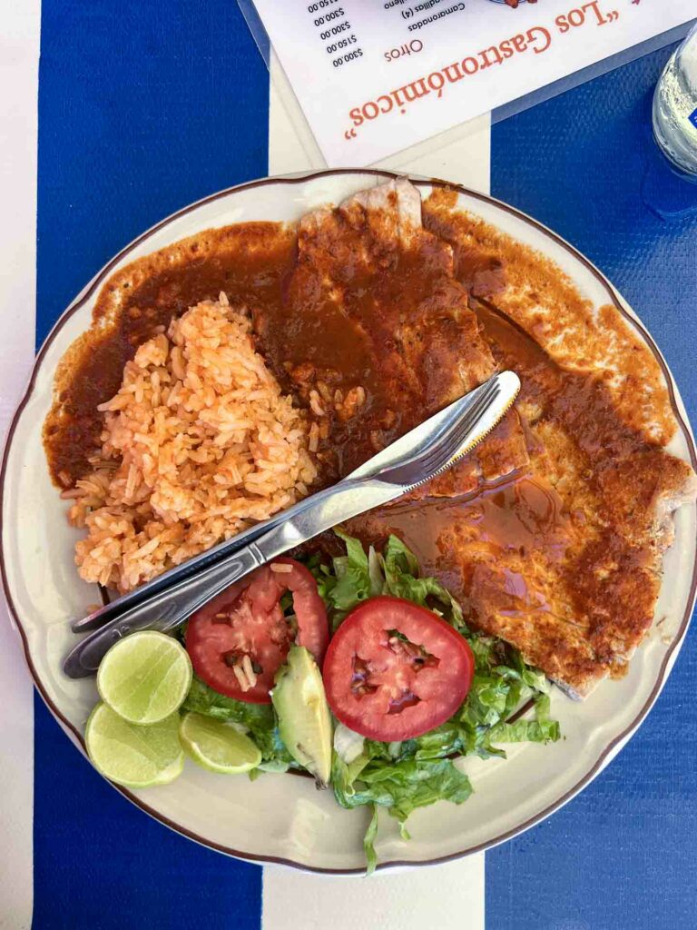 Fish a la diabla on blue and white striped table typical Puerto Escondido food