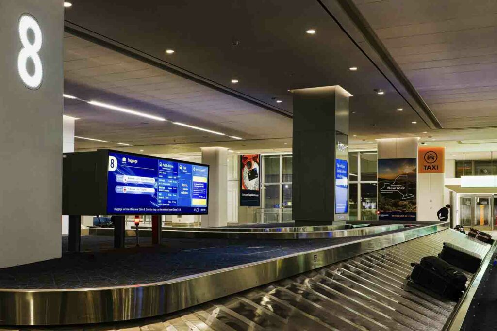 Baggage claim in airport, several bags on turnstile
