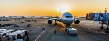 Plane at sunset on airport tarmac