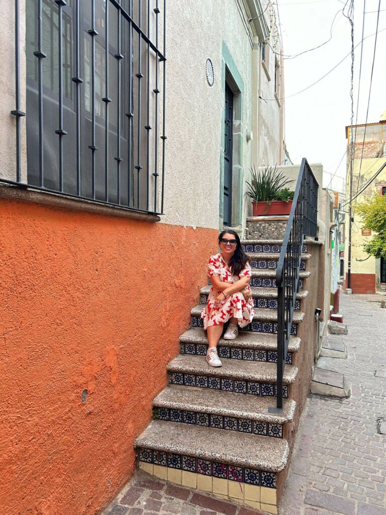 Ayngelina sitting on stairs in Guanajuato Mexico