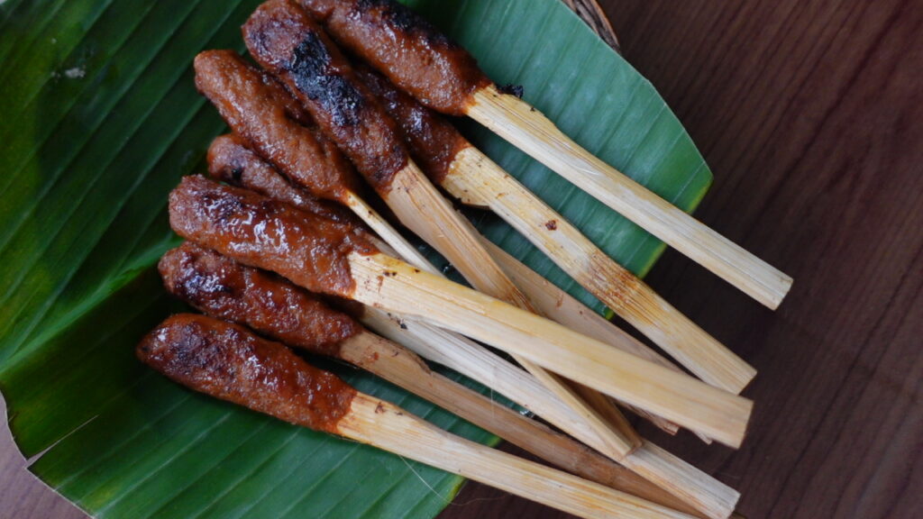 Sate Pusut skewers on a banana leaf in Lombok Indonesia
