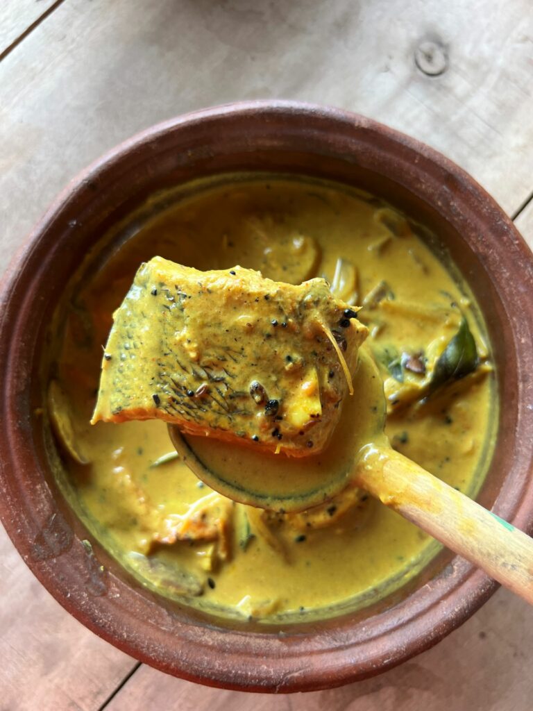 Jaffna fish curry Meen Kulambu) a traditional Sri Lankan dish in a clay bowl 