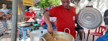 Vendor selling cazuela traditional food in Santa Marta Colombia