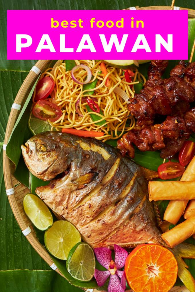 Banana leaf with traditional Filipino food of Palawan, grilled fish, noodles and vegetables.