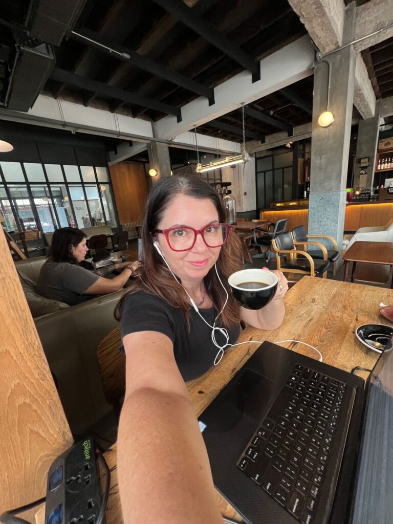Ayngelina working on laptop at cafe