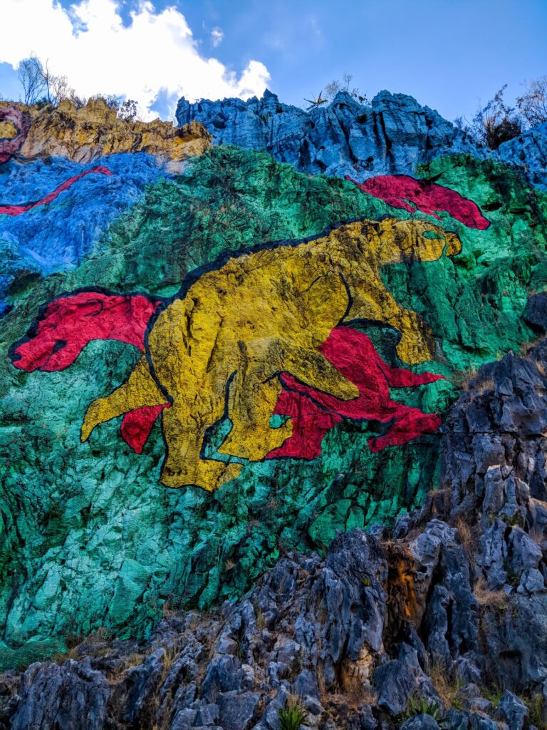 Mural de la Prehistoria is a massive 120-meter by 160-meter open-air fresco painted on the side of the Mogote Dos Hermanas in the Viñales Valley.
