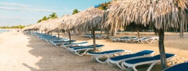 Trinidad cuba playa ancon hotel beach chairs with palm umbrella coverings