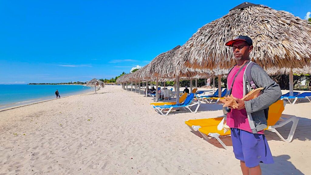 Fisherman selling starfish and conch at Playa Ancon in Trinidad Cuba