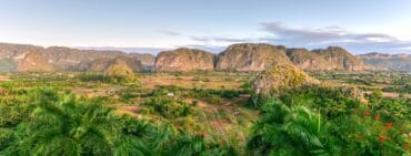 VInales Valley at dusk with view of the mogotes and lush foliage and flowers in the foreground