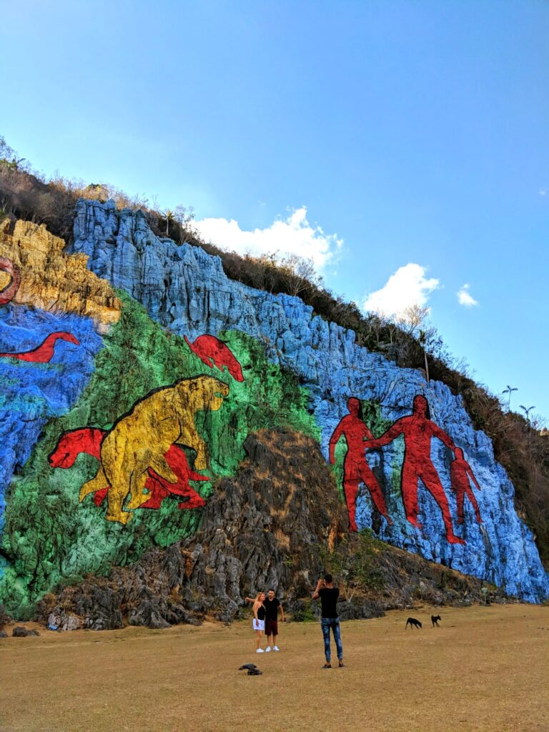 Mural de la Prehistoria is a massive 120-meter by 160-meter open-air fresco painted on the side of the Mogote Dos Hermanas in the Viñales Valley.