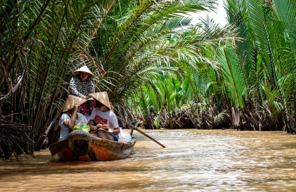 Vietnamese in river boat on Mekong River