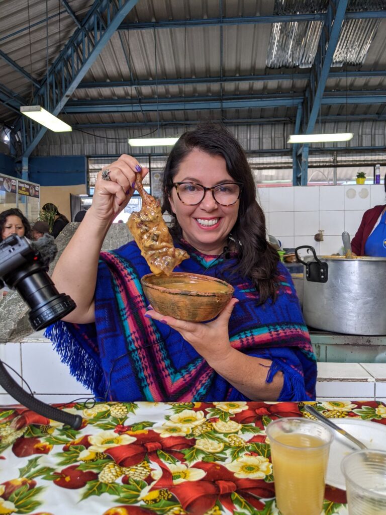 Ayngelina eating cuy Guinea pig in Cotacachi